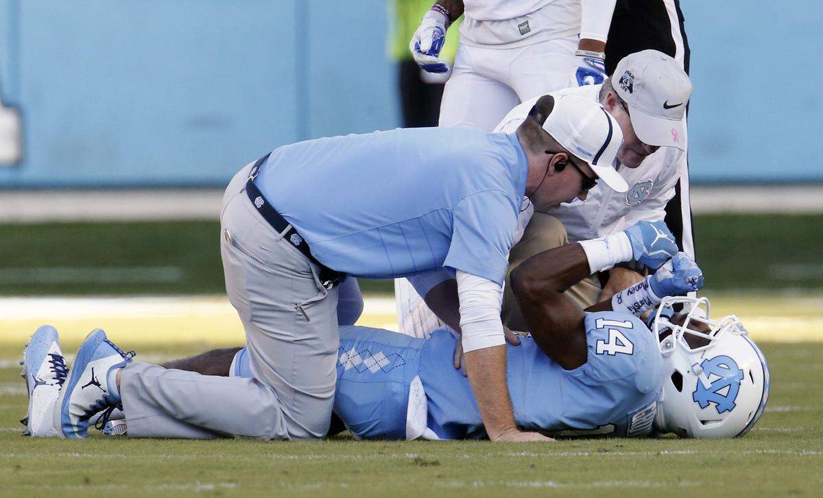 Trainers tend to UNC’s Rontavius Groves after an injury during the fourth quarter of an ACC football game between the UNC Tar Heels and the Duke Blue Devils played at Kenan Stadium in Chapel Hill, NC, on Sept. 23, 2017. Duke beat UNC 27-17.