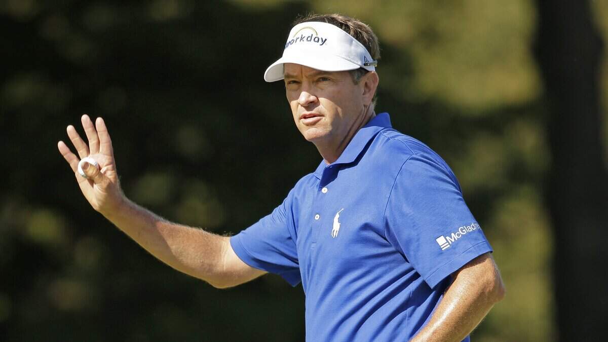 Davis Love III waves to the crowd on the 18th hole during the final round of the Wyndham Championship golf tournament at Sedgefield Country Club in Greensboro, N.C., Sunday, Aug. 23, 2015. Love won the tournament. (AP Photo/Chuck Burton)