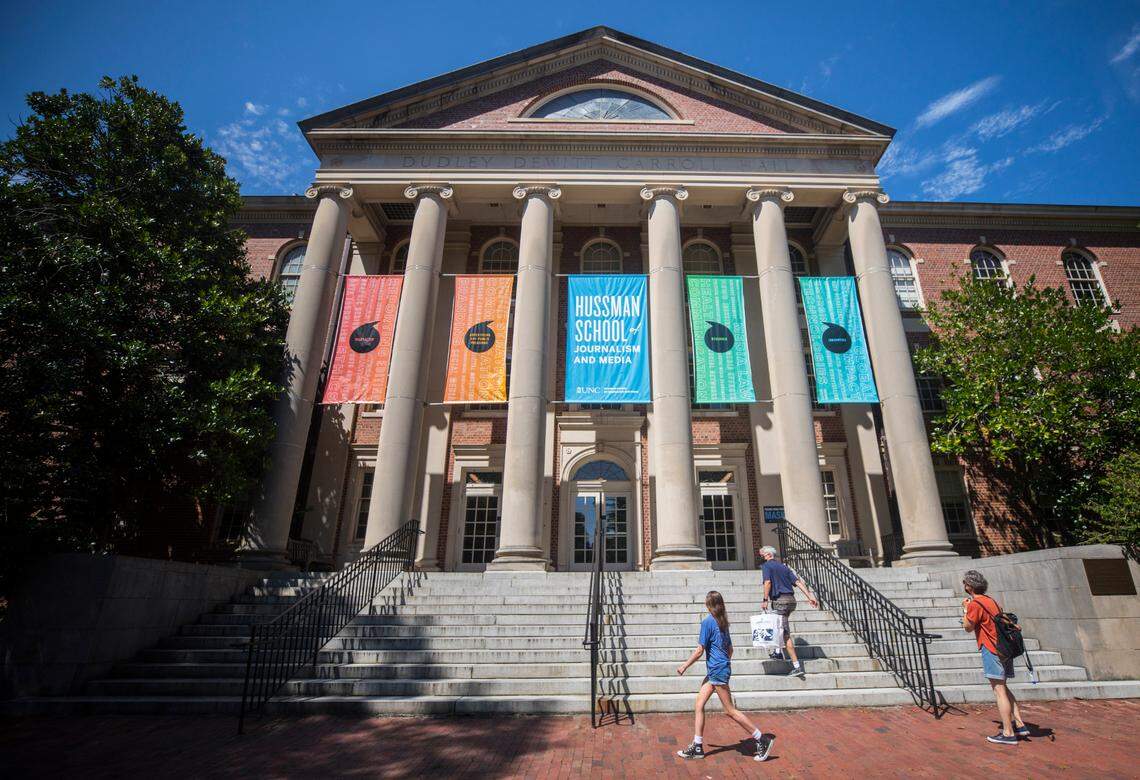 Visitors of UNC-Chapel Hill walk up the steps of Carroll Hall, the building housing the Hussman School of Journalism and Media, in Chapel Hill, N.C. on Wednesday, July 14, 2021.