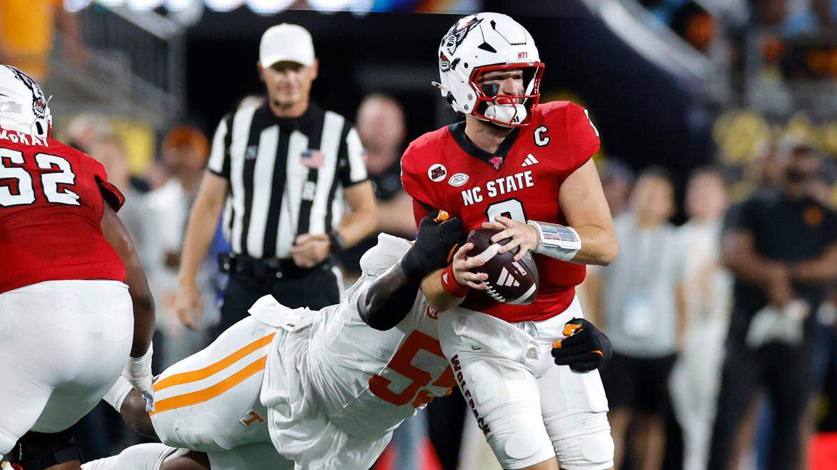 N.C. State quarterback Grayson McCall (2) is sacked by Tennessee defensive lineman Omarr Norman-Lott (55) during the first half of N.C. State’s game against Tennessee in the Duke’s Mayo Classic at Bank of America Stadium in Charlotte, N.C., Saturday, Sept. 7, 2024.