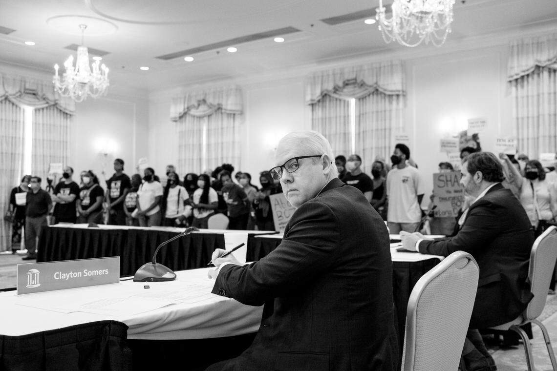 Clayton Sommers, Vice Chancellor for Public Affairs of The University for the University of North Carolina at Chapel Hill, stares as Black students lead a demonstration during the board of trustee meeting to make a tenure decision for Nikole Hannah-Jones. In 1979 Black students lead a similar demonstration when a qualified Black professor, Sonya Haynes Stone, was denied tenure.