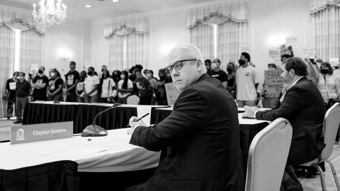 Clayton Sommers, Vice Chancellor for Public Affairs of The University for the University of North Carolina at Chapel Hill, stares as Black students lead a demonstration during the board of trustee meeting to make a tenure decision for Nikole Hannah-Jones. In 1979 Black students lead a similar demonstration when a qualified Black professor, Sonya Haynes Stone, was denied tenure.
