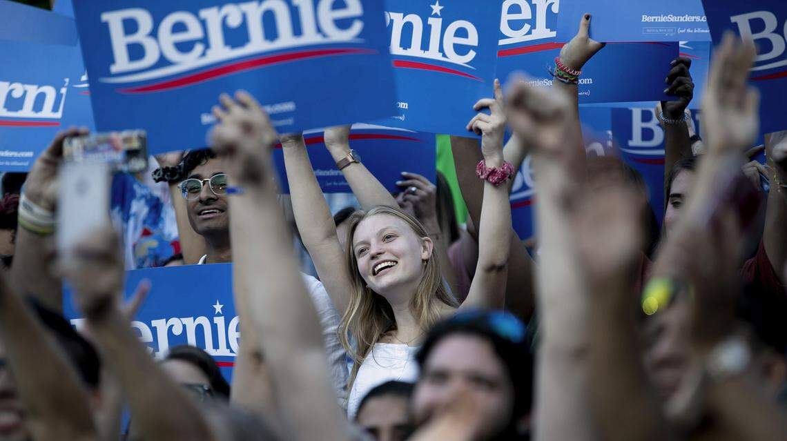 Supporters raise their signs as democratic presidential candidate Sen. Bernie Sanders arrives for a rally on Thursday, September 19, 2019 at the University of North Carolina in Chapel Hill, N.C.