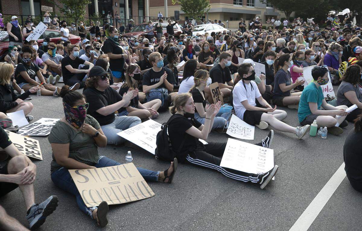 Protesters fill in Hillsborough Street near the North Carolina GOP headquarters during a rally on Tuesday, June 2, 2020 in Raleigh, N.C.