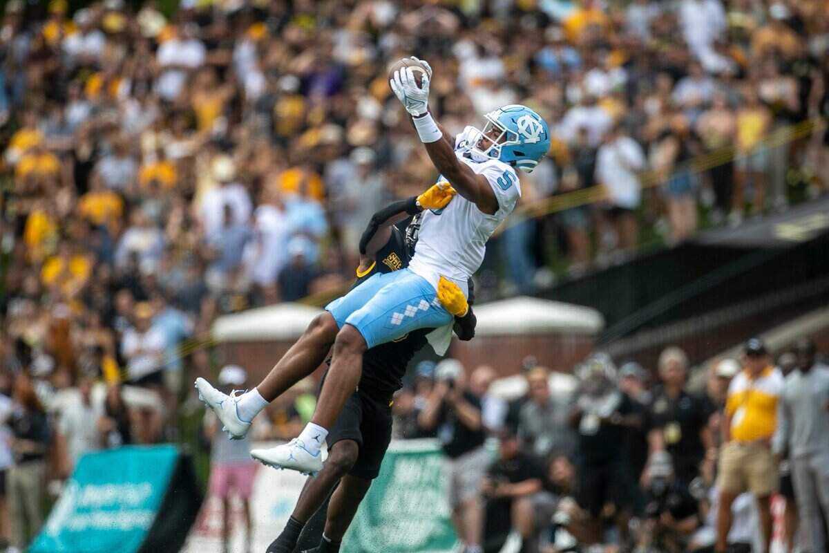 North Carolinas J.J. Jones (5) pulls in a pass from quarterback Drake Maye (10) for a 31-yard gain in the first quarter against Appalachian States Steven Jones Jr. (6) on Saturday, September 3, 2022 at Kidd Brewer Stadium in Boone, N.C.