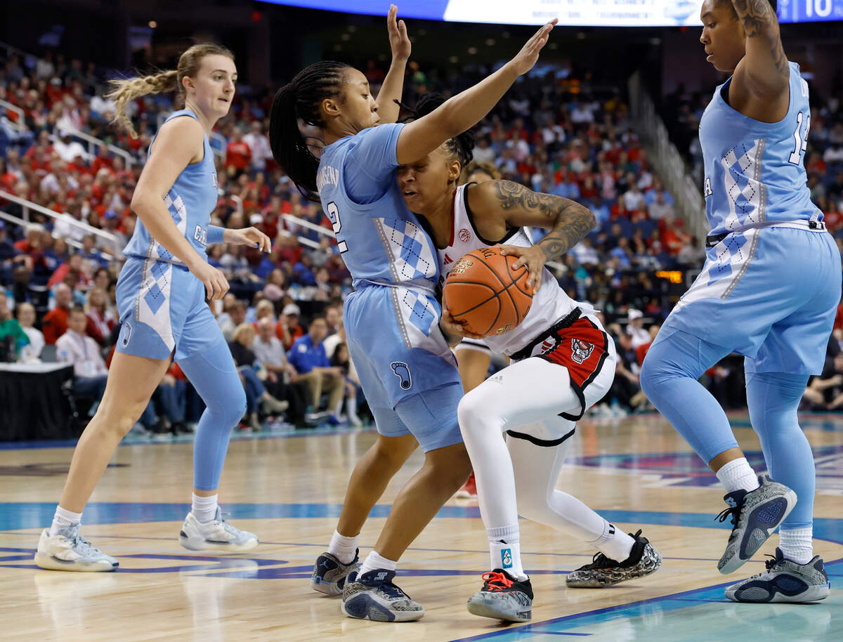 N.C. State’s Aziaha James drives past North Carolina’s Grace Townsend during the second half of the Wolfpack’s 66-55 win in the ACC Tournament semifinals on Saturday, March 8, 2025, at First Horizon Coliseum in Greensboro, N.C.
