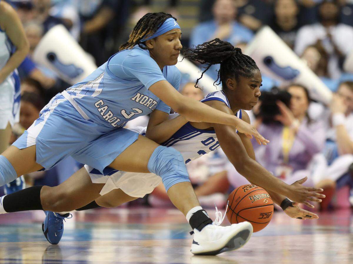 North Carolina’s Kennedy Todd-Williams and Duke’s Shayeann Day-Wilson dive for a loose ball during the second half of the Blue Devils’ 44-40 win over North Carolina in an ACC Women’s Basketball Tournament quarterfinal game on Friday, March 3, 2023, at Greensboro Coliseum in Greensboro, N.C.