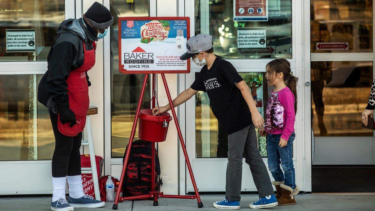 Ernestine McDade, a Salvation Army bell ringer, accepts donations from shoppers at Hobby Lobby on Capital Boulevard in Raleigh Friday, Nov. 20, 2020.