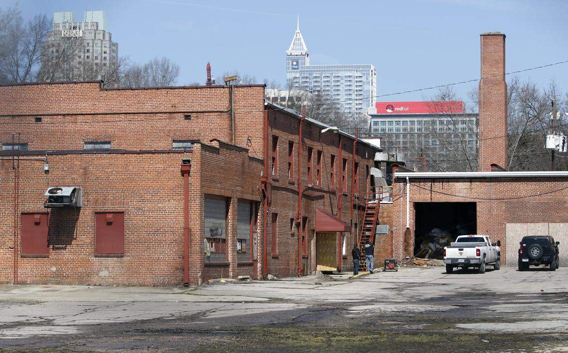 As of Monday, March 3, 2015, a large piece of demolition machinery had been offloaded just inside the property line fence of the old Greyhound ‘Carolina Coach’ warehouse and outbuilding complex in downtown south Raleigh and workers were on site inside the large building at left. Demolition permits have been approved by the City of Raleigh for four of the five buildings on the block square site.