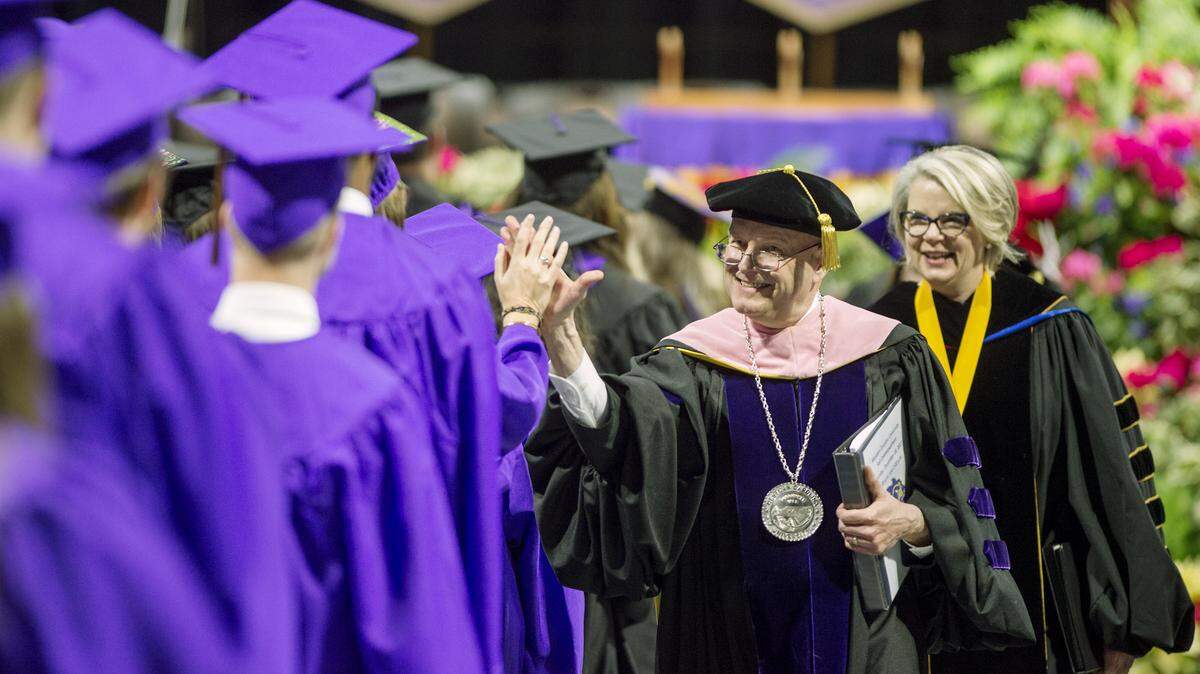 Western Carolina University Chancellor David Belcher high-fives graduates last December at commencement.