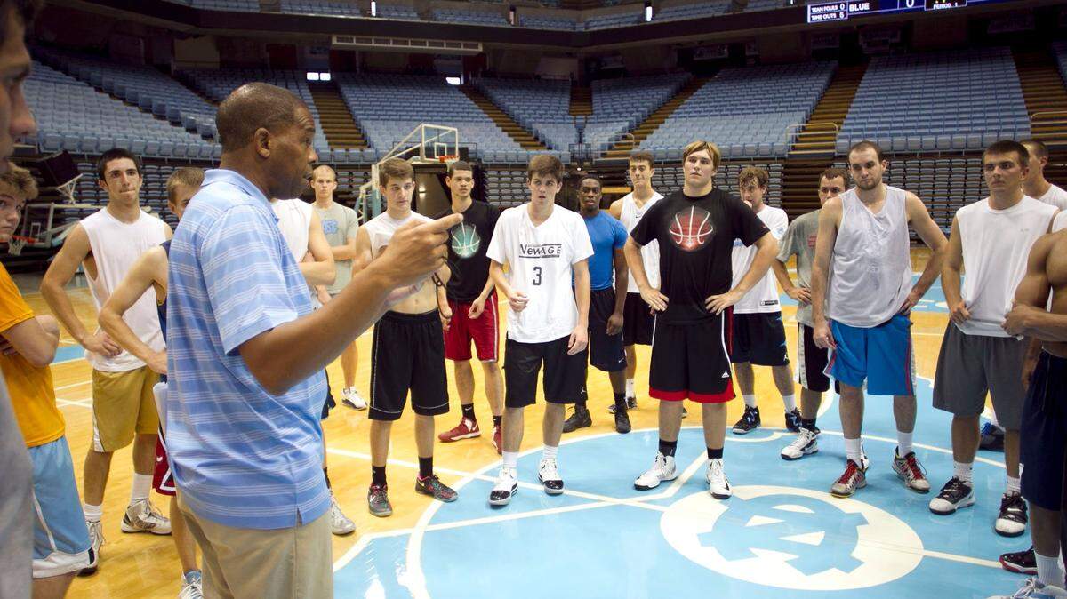 UNC Jayvee basketball coach Hubert Davis huddles with those trying out for the team on the first of two days of tryouts on Thursday October 3, 2013 at the Smith Center in Chapel Hill, N.C.