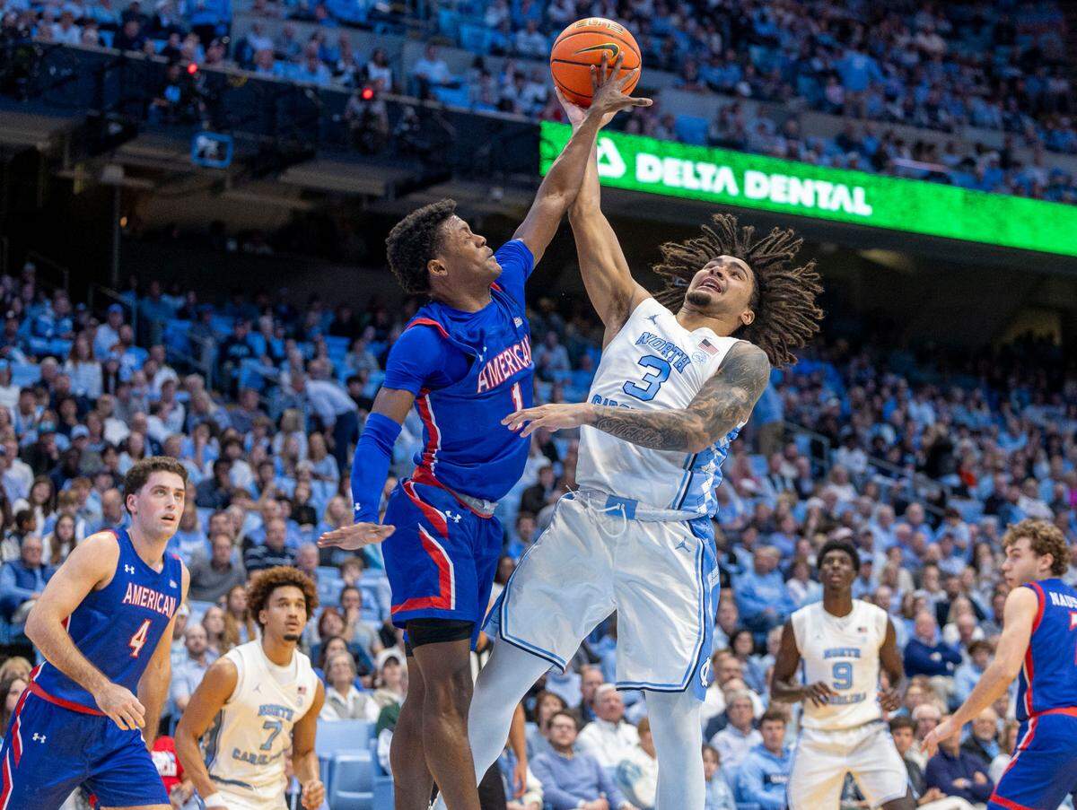 American University guard Elijah Stephens (1) defends North Carolina guard Elliot Cadeau (3) in the first half on Friday, November 15, 2024 at the Smith Center in Chapel Hill, N.C.