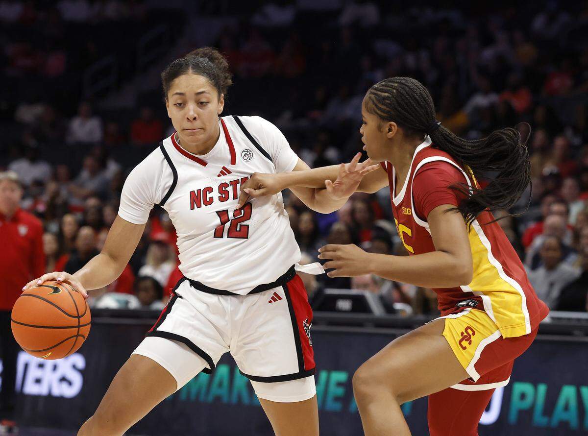 N.C. State’s Khamil Pierre handles the ball against Southern California’s Kara Dunn during the first half of the Wolfpack’s 69-68 loss in the Ally Tipoff game on Sunday, Nov. 9, 2025, at Spectrum Center in Charlotte, N.C.