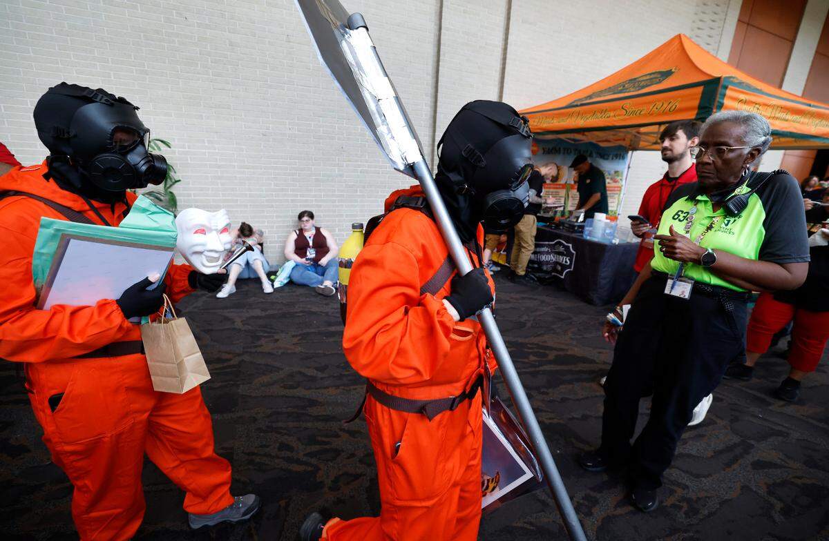 Traci Overstreet from Houston, Texas, left, and Laura Lee from Franklinton attend GalaxyCon Raleigh at the Raleigh Convention Center Sunday, July 28, 2024. The two are dressed as Lethal Company employees.