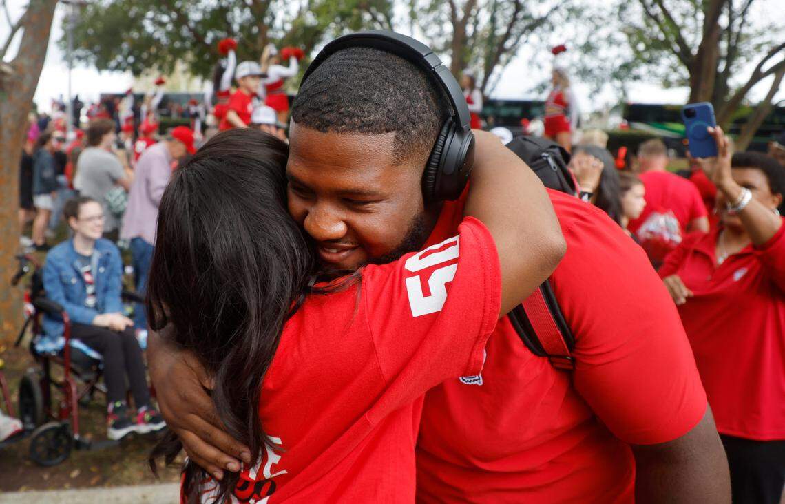 N.C. State center Grant Gibson gets hugs from friends and family during the Walk of Champions before N.C. State’s game against Boston College at Carter-Finley Stadium in Raleigh, N.C., Saturday, Nov. 12, 2022.