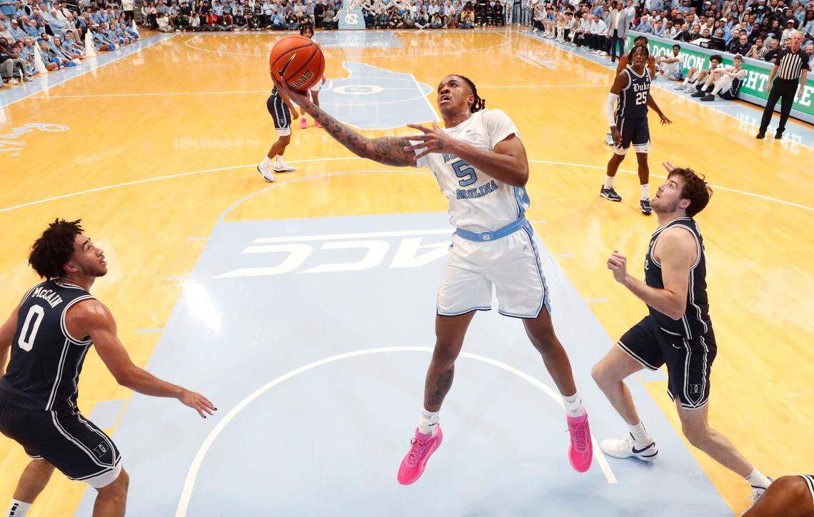 North Carolina’s Armando Bacot (5) shoots as he drives past Duke’s Ryan Young (15) during UNC’s 93-84 victory over Duke at the Smith Center in Chapel Hill, N.C., Saturday, Feb. 3, 2024.