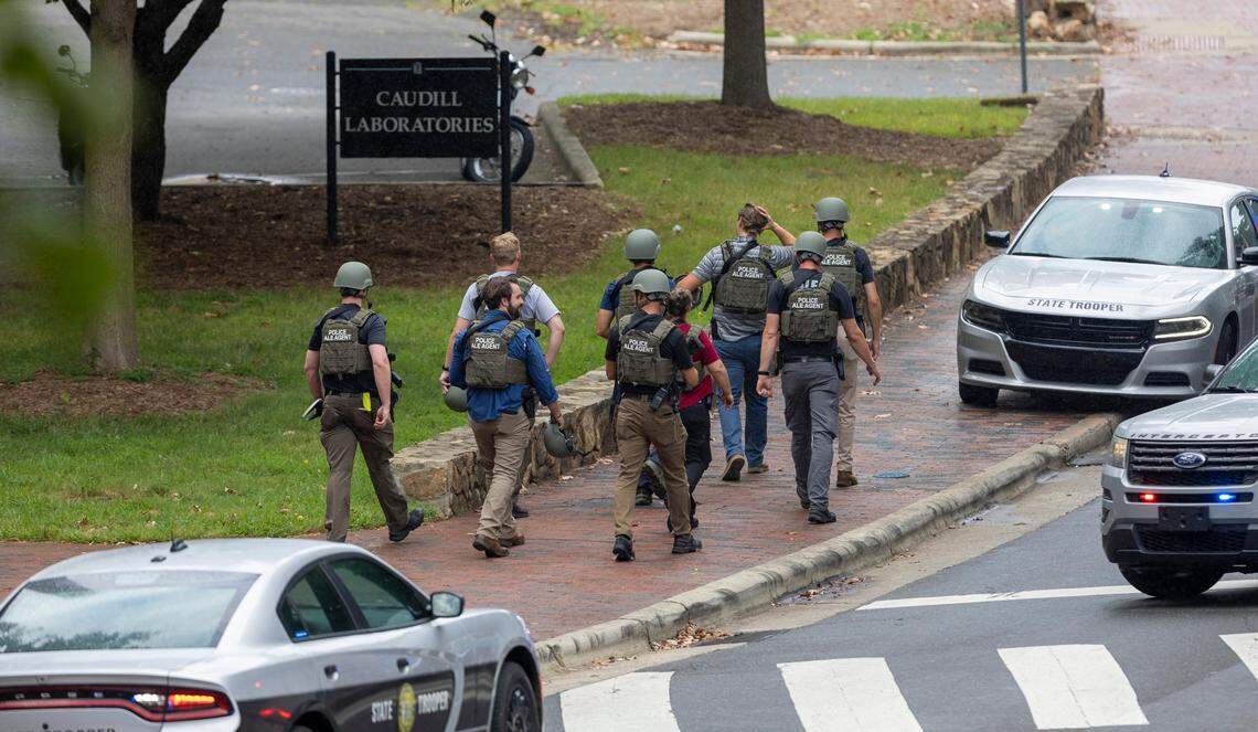 North Carolina ALE Agents exit the Caudill Laboratories building near the Bell Tower on the University of North Carolina campus after a report of an armed and dangerous person on Monday, August 28. 2023 in Chapel Hill, N.C. Tailei Qi, 34, a graduate student was arrested in the shooting at UNC-Chapel Hill on Monday that left a member of the faculty dead and put the entire campus on lockdown for more than three hours.