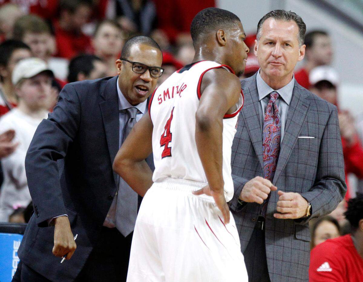 N.C. State assistant coach Orlando Early, left, and head coach Mark Gottfried talk with Dennis Smith Jr. during the Wolfpack’s game against Wake Forest at PNC Arena in Raleigh, N.C., Saturday, Jan. 21, 2017.