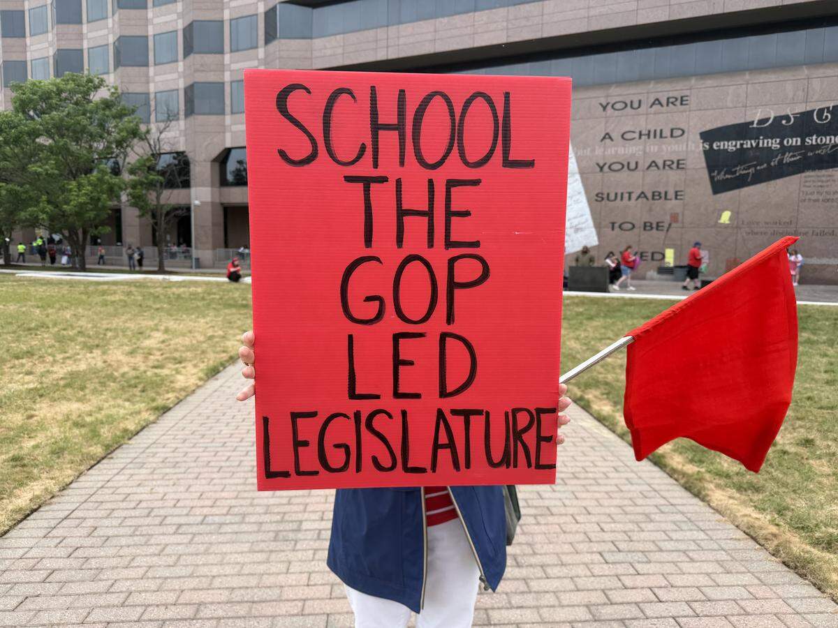 A protester displays their sign supporting teachers before the march in downtown Raleigh.