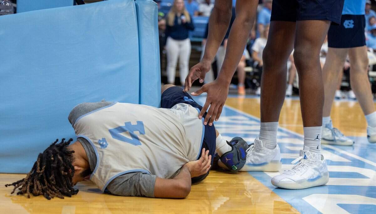 North Carolina’s James Brown (2) reaches to check on R.J. Davis (4) after a hard foul in the second half during the Tar Heels’ Blue vs. White scrimmage on Saturday, October 12, 2024 at the Smith Center in Chapel Hill, N.C. Davis did not play the rest of the scrimmage.