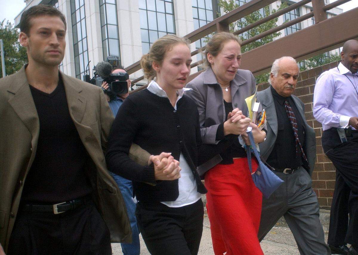 Todd Peterson, left, and defense investigator Ron Guerette , far right, lead Martha and Margaret Ratliff from the Durham County Courthouse after Michael Peterson, Todd’s father and the Ratliff’s guardian, was found guilty of first degree murder in the death of his wife Kathleen Peterson.