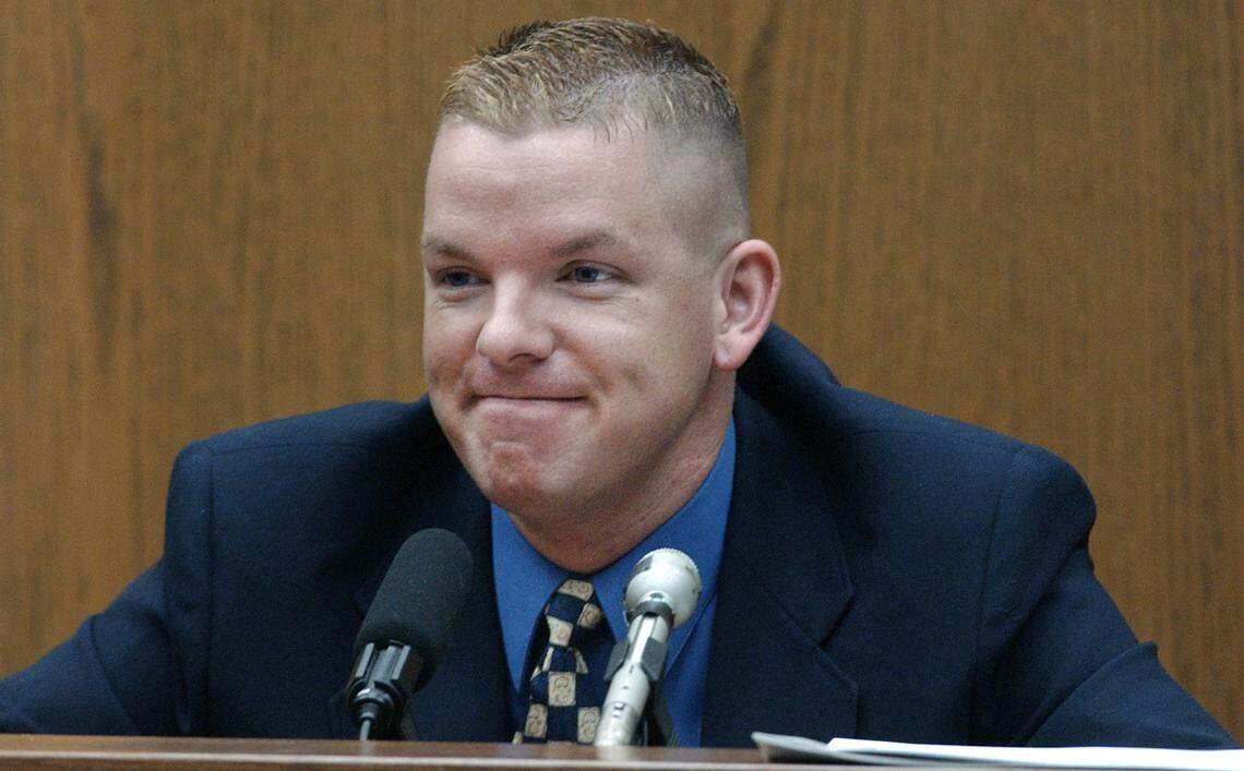 Self-described male escort Brent Wolgamott, 28, of Raleigh, grins at defense attorney David Rudolf after saying some of his “clients” were doctors and lawyers and even one judge during his testimony in the 2003 Michael Peterson murder trial.