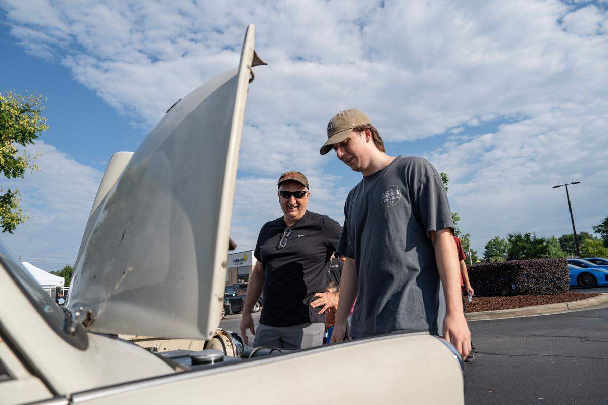 Noah Armbruster looks under the hood of his Trabant at Cars and Coffee Morrisville on June 7, 2025