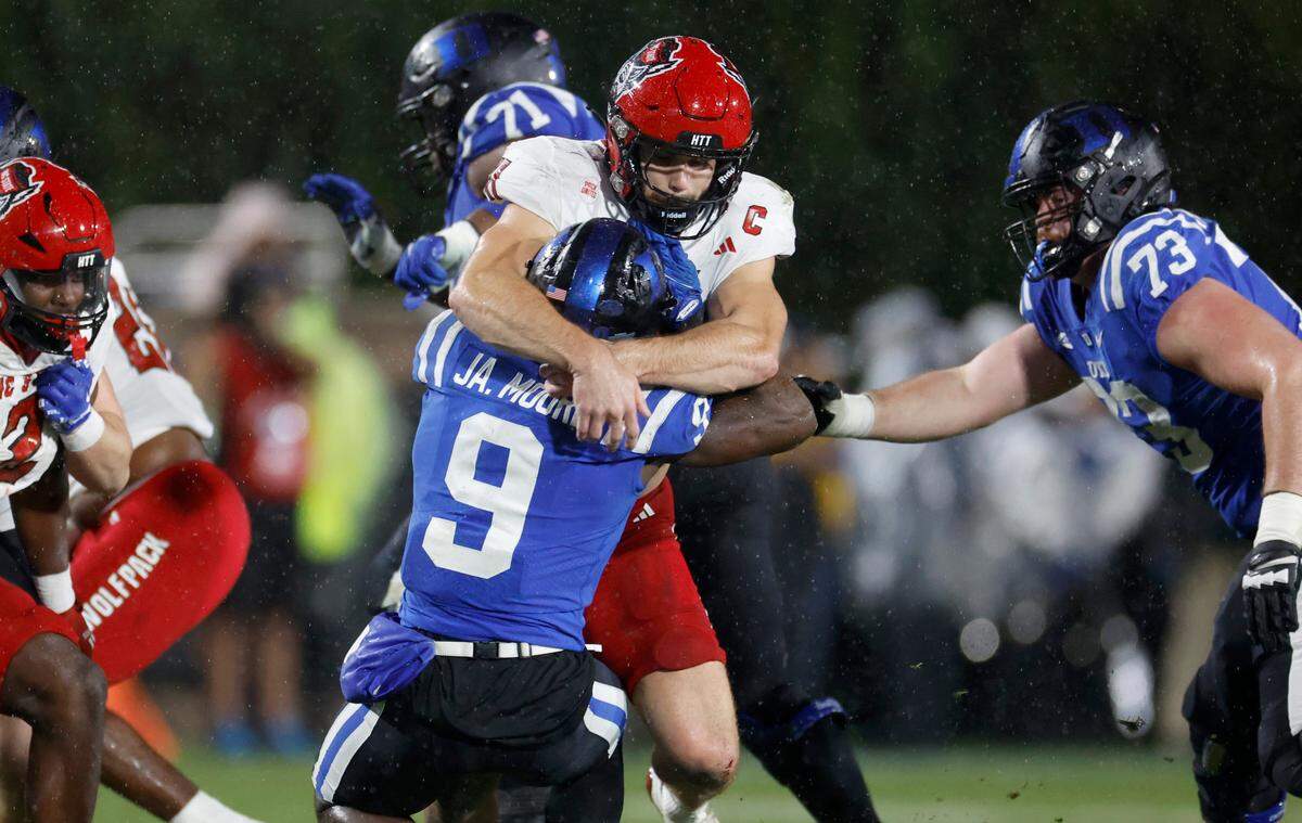 N.C. State linebacker Payton Wilson (11) tackles Duke running back Jaquez Moore (9) during the first half of N.C. State’s game against Duke at Wallace Wade Stadium in Durham, N.C., Saturday, Oct. 14, 2023.
