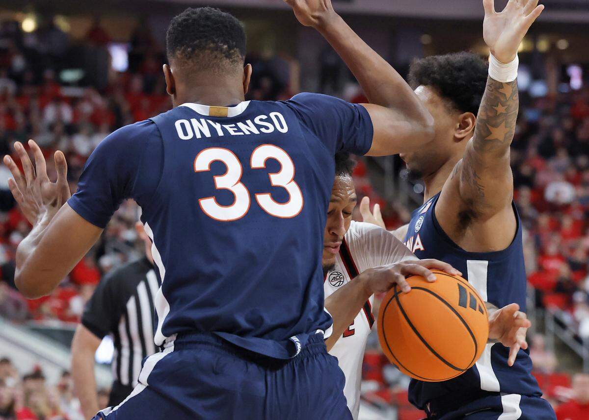 N.C. State’s Darrion Williams drives between Virginia’s Ugonna Onyenso and Malik Thomas during the first half of the Wolfpack’s game on Saturday, Jan. 3, 2026, at Lenovo Center in Raleigh, N.C.