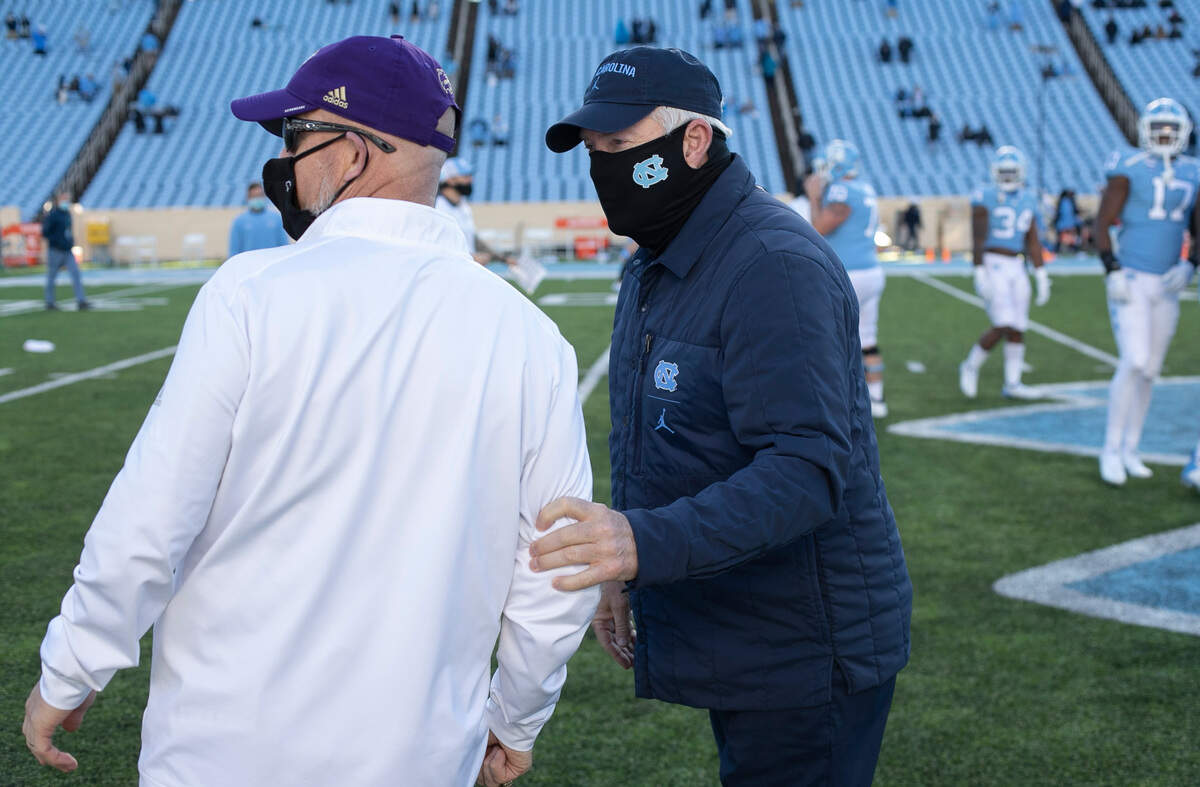 Western Carolina head coach Mark Speir and North Carolina coach Mack Brown meet at mid-field following the Tar Heels’ 49-9 victory on Saturday, December 5, 2020 at Kenan Stadium in Chapel Hill, N.C.