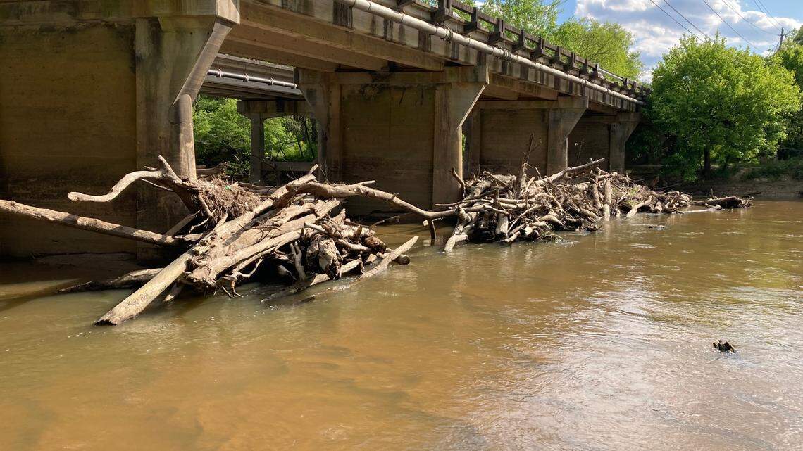 Contractors will break up these piles of logs and other debris that are blocking the Neuse River in Raleigh.