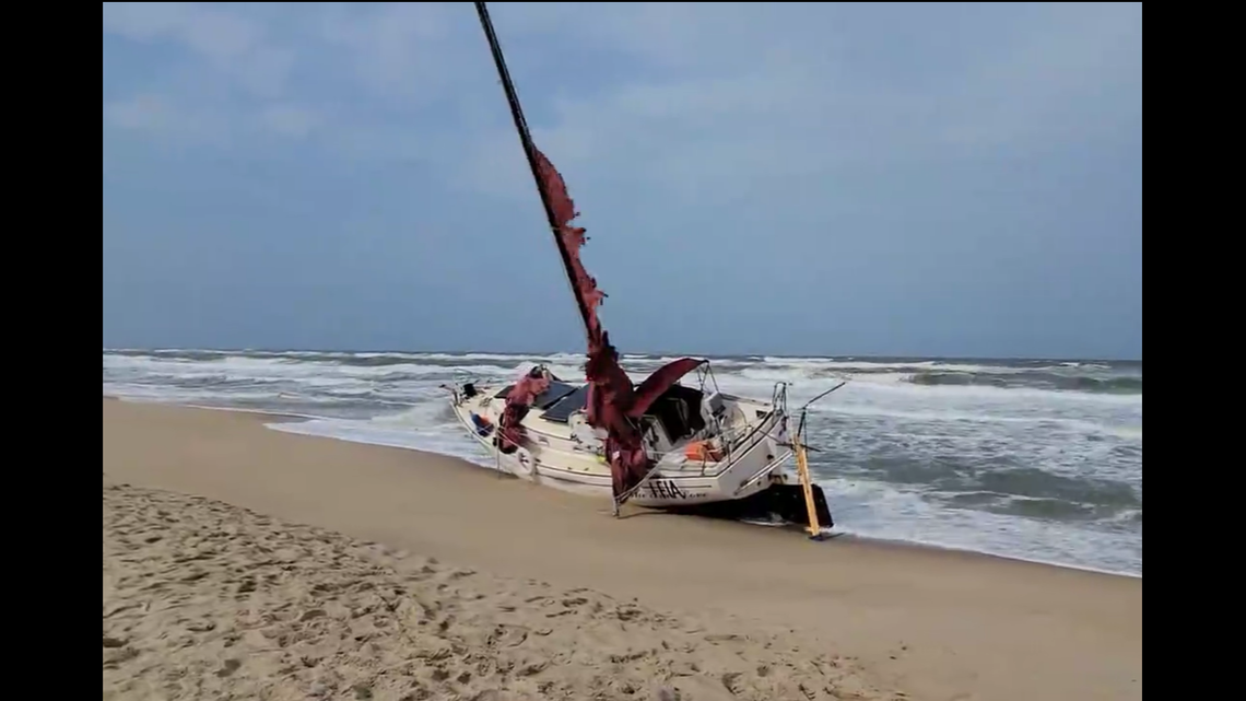 Sailboat minus its crew washes ashore at Nags Head on North Carolina’s Outer Banks. Crew was rescued by U.S Coast Guard off shore.