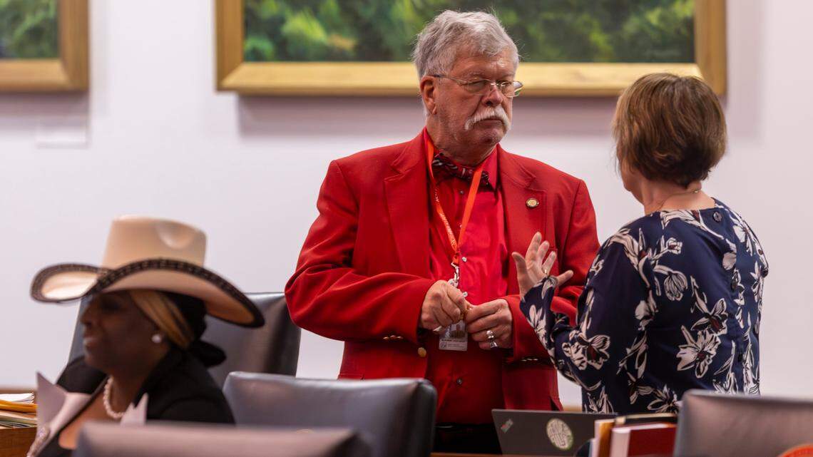 State Rep. Mike Clampitt, a Bryson City Republican, speaks with another lawmaker on the House floor on Wednesday, Dec. 11, 2024.