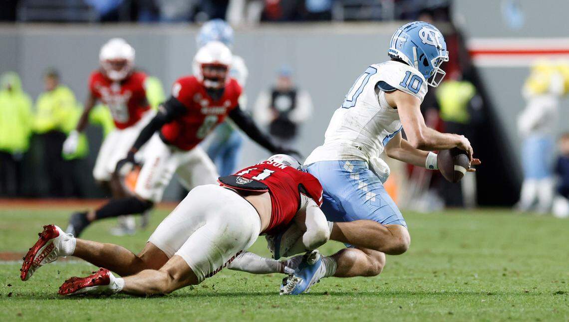 N.C. State linebacker Payton Wilson (11) sacks North Carolina quarterback Drake Maye (10) during the second half of N.C. State’s 39-20 victory over UNC at Carter-Finley Stadium in Raleigh, N.C., Saturday, Nov. 25, 2023.