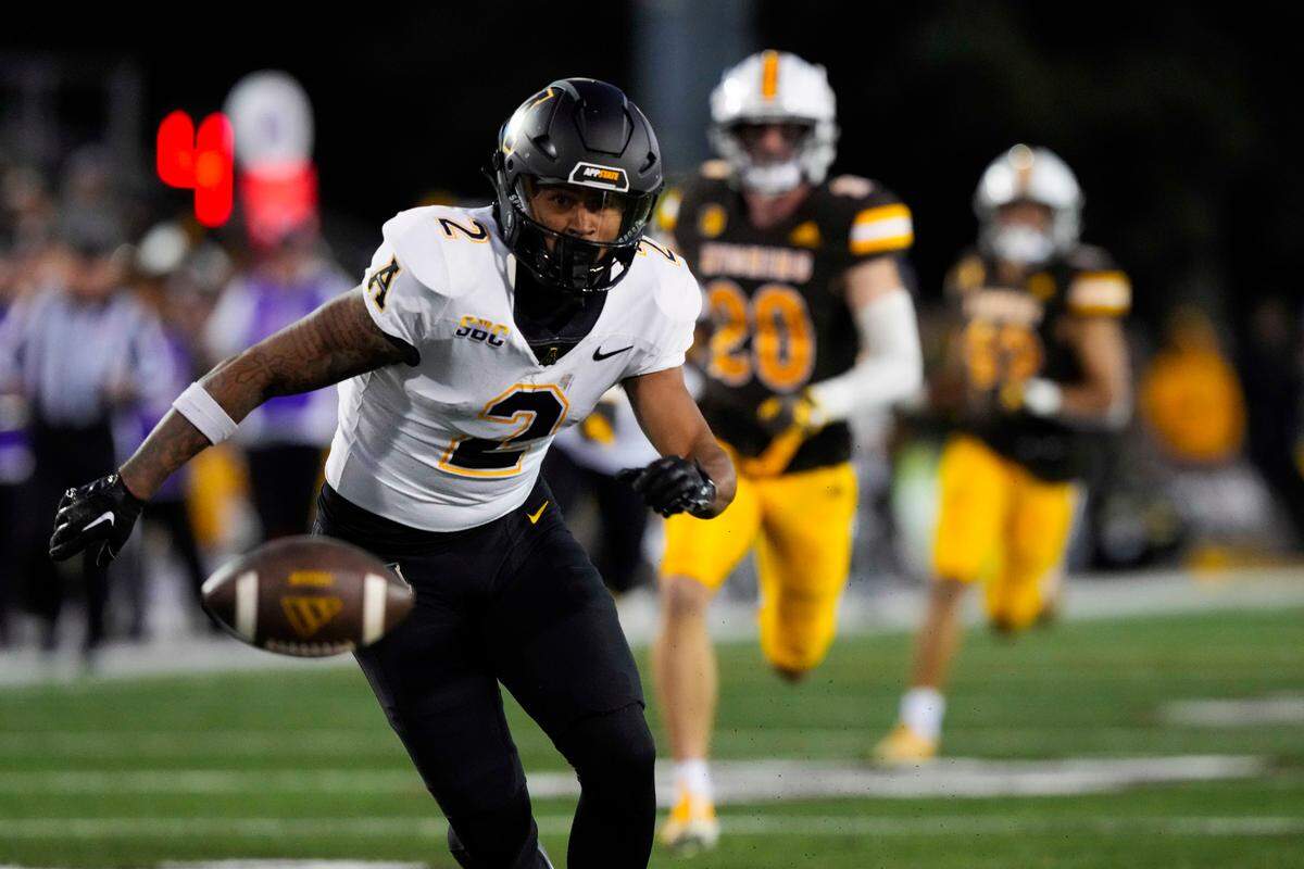 Sep 23, 2023; Laramie, Wyoming, USA; Appalachian State Mountaineers cornerback Tyrek Funderburk (2) mishandles a punt against the Wyoming Cowboys during the third quarter at Jonah Field at War Memorial Stadium. Mandatory Credit: Troy Babbitt-USA TODAY Sports