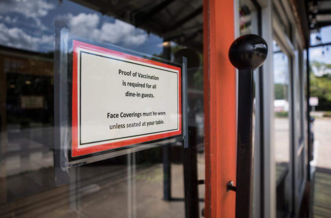 A sign on the door of Pizzeria Mercato in Carrboro, N.C., pictured here on Thursday, Aug. 26, 2021, states that dine-in guests must show proof of vaccination.