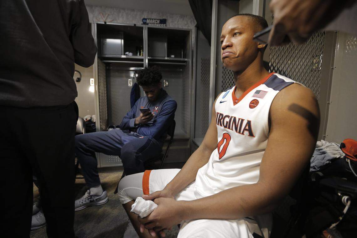 Virginia's Devon Hall (0) takes questions from the media in the locker room after losing to UMBC in a first-round game in the NCAA men's college basketball tournament in Charlotte, N.C., Friday, March 16, 2018.