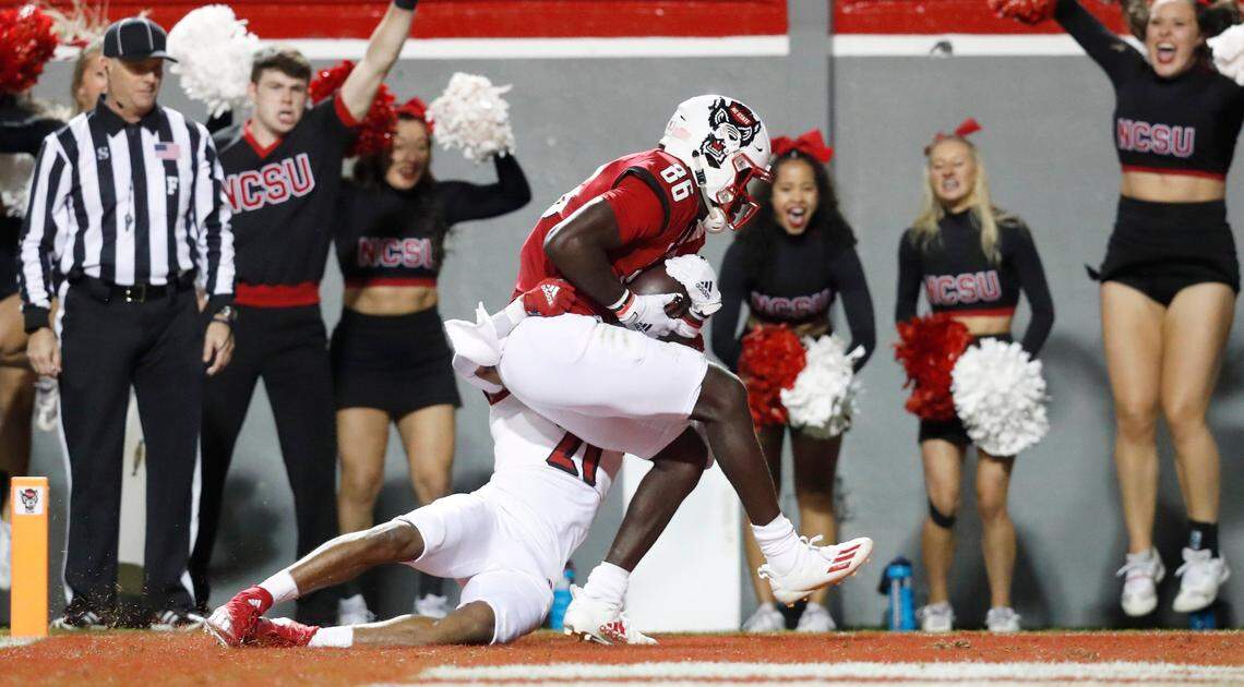 N.C. State wide receiver Emeka Emezie (86) scores on a 19-yard touchdown reception as Louisville defensive back Greedy Vance (21) defends during the first half of N.C. States game against Louisville at Carter-Finley Stadium in Raleigh, N.C., Saturday, October 30, 2021.