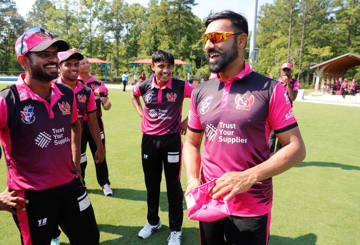 Jaskaran Malhotra, Morrisville’s captain, right, laughs with teammates before a match between the Morrisville Cardinals and the Atlanta Param Veers during the inaugural Toyota Minor League Cricket Championship at Church Street Park in Morrisville, N.C., Sunday, August 8, 2021.
