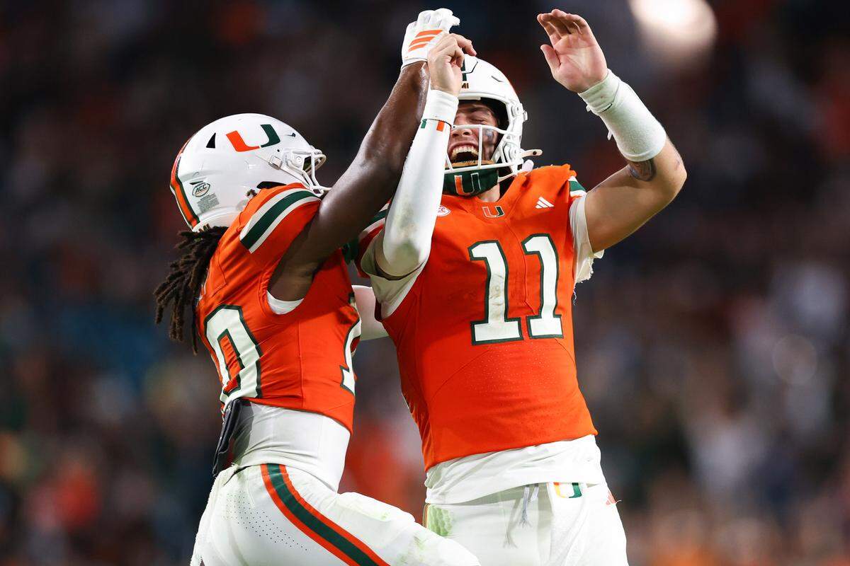 Malachi Toney, left, and Carson Beck of the Miami Hurricanes celebrate a touchdown against the Syracuse Orange during the third quarter of the game at Hard Rock Stadium on Nov. 8, 2025 in Miami Gardens, Florida.