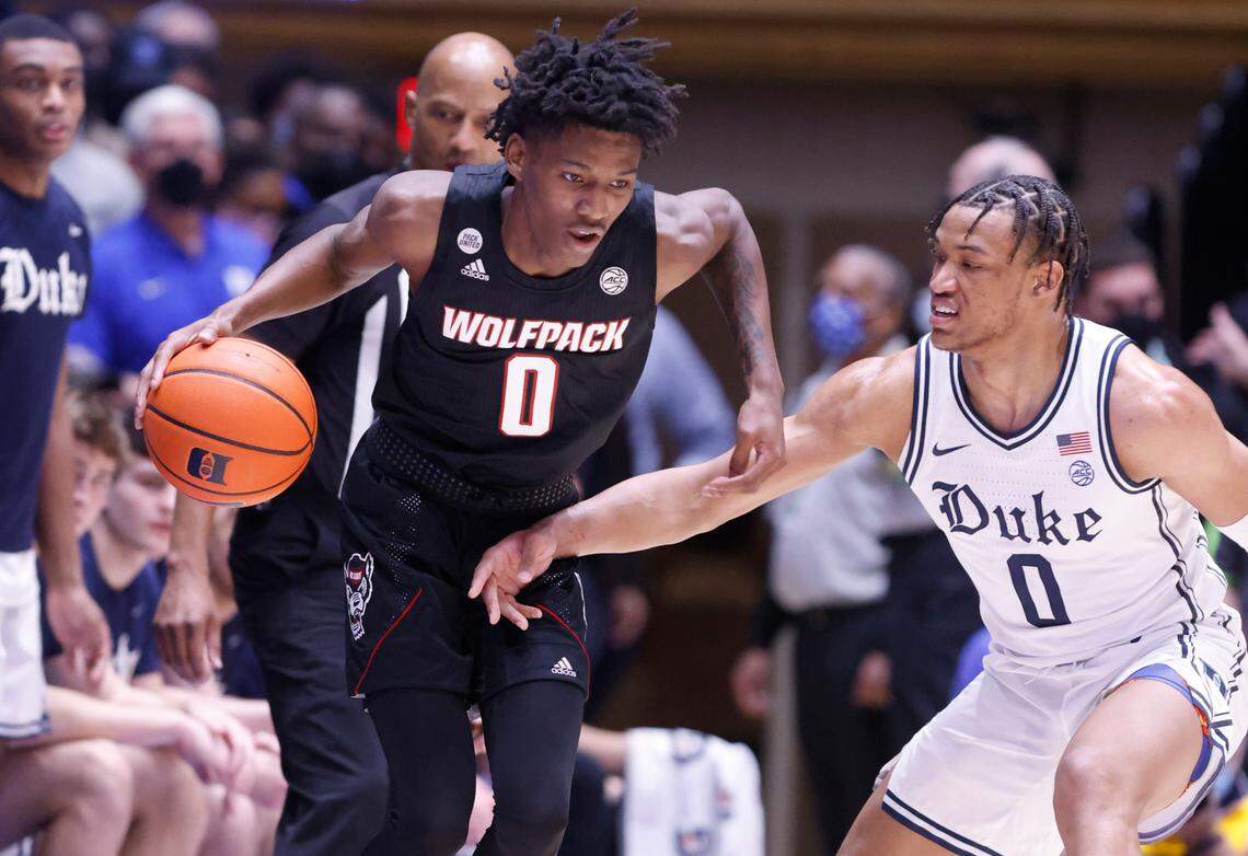 N.C. State’s Terquavion Smith (0) drives around Duke’s Wendell Moore Jr. (0) during the first half of Duke’s game against N.C. State at Cameron Indoor Stadium in Durham, N.C., Saturday, January 15, 2022.
