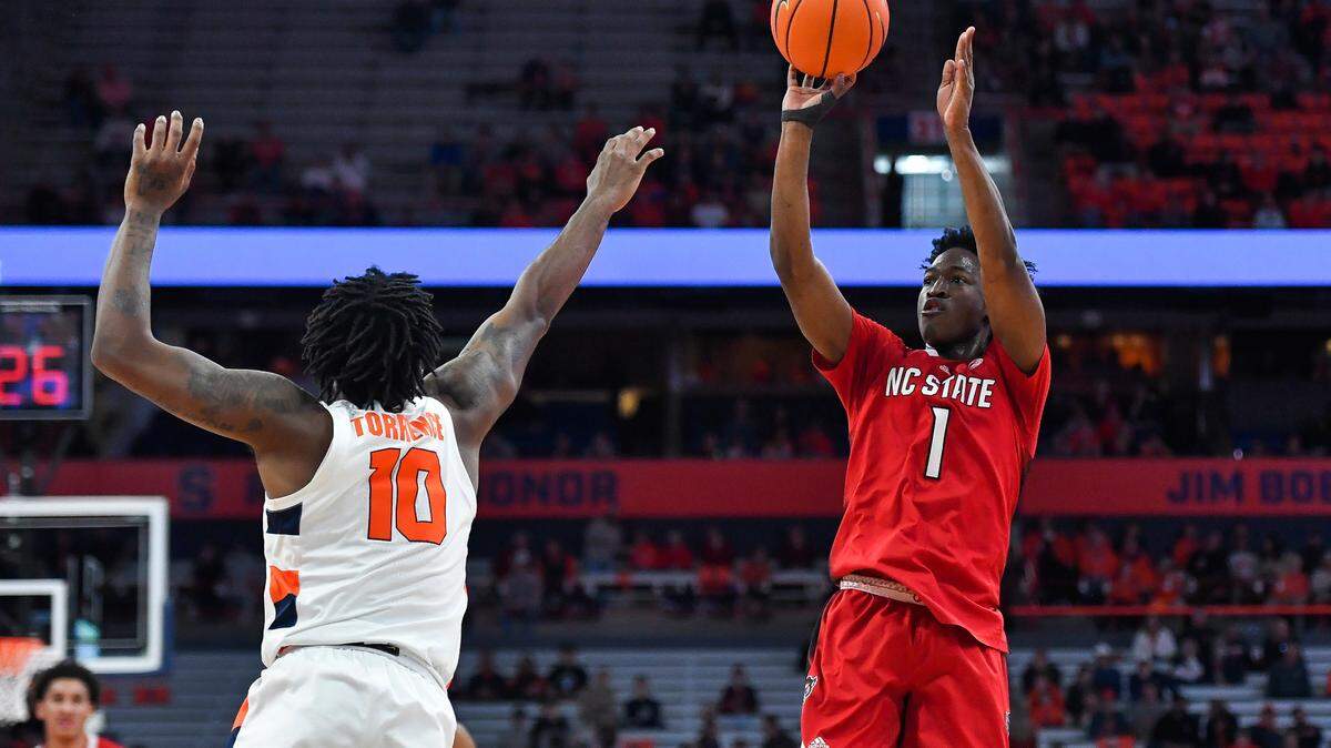 North Carolina State guard Jarkel Joiner, right, shoots over Syracuse guard Symir Torrence during the first half of an NCAA college basketball game in Syracuse, N.Y., Tuesday, Feb. 14, 2023. (AP Photo/Adrian Kraus)