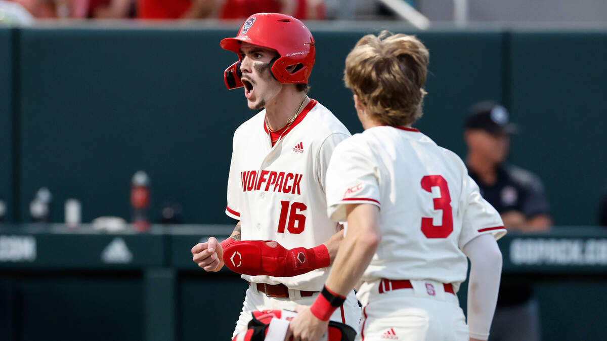 N.C. State’s Eli Serrano III (16) celebrates with Brandon Butterworth (3) after Serrano III scored after the Wolfpack’s Alex Sosa walked with the bases loaded in the seventh inning during N.C. State’s 6-4 victory over South Carolina in the NCAA Raleigh Regional at Doak Field Saturday, June 1, 2024.