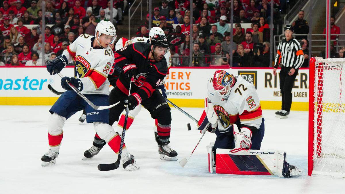 Carolina Hurricanes left wing Jordan Martinook (48) shot attempt is stopped by Florida Panthers goaltender Sergei Bobrovsky (72) and defenseman Gustav Forsling (42) during the first period at PNC Arena.