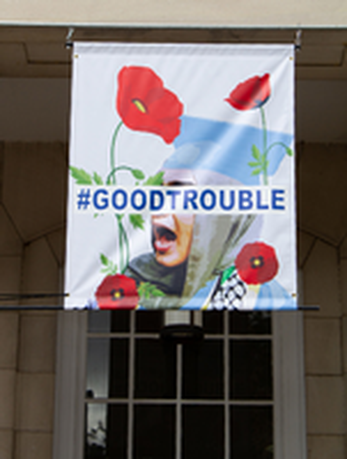 A banner showing a woman wearing a hijab and a blue graduation cap drew criticism in Chapel Hill and has been removed from Peace & Justice Plaza.