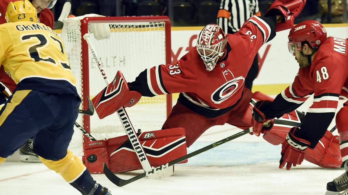 Carolina Hurricanes goaltender Scott Darling (33) blocks a shot by Nashville Predators center Rocco Grimaldi (23) during the second period of an NHL preseason hockey game Tuesday, Sept. 25, 2018, in Nashville, Tenn.