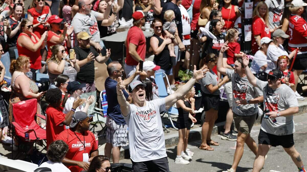 The Hurricanes coach Rod Brind’Amour acknowledges the crowds during a parade and rally for the Carolina Hurricanes in downtown Raleigh Saturday, June 20, 2026.