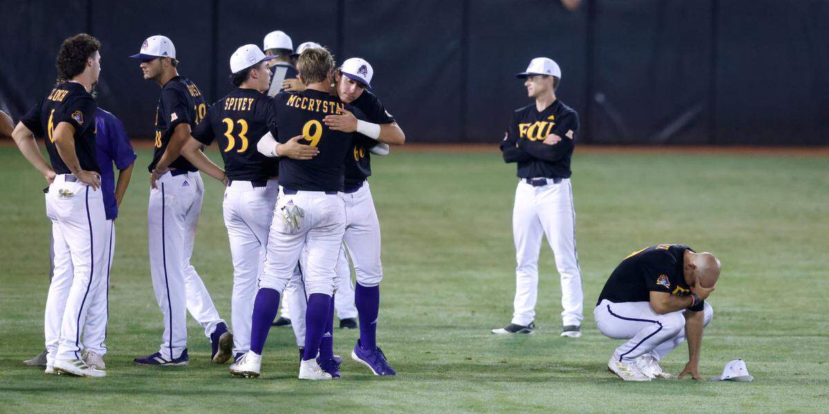 East Carolina players console each other after Texas’ 11-1 victory over ECU to win the Greenville Super Regional at Clark-LeClair Stadium early Monday morning, June 13, 2022.
