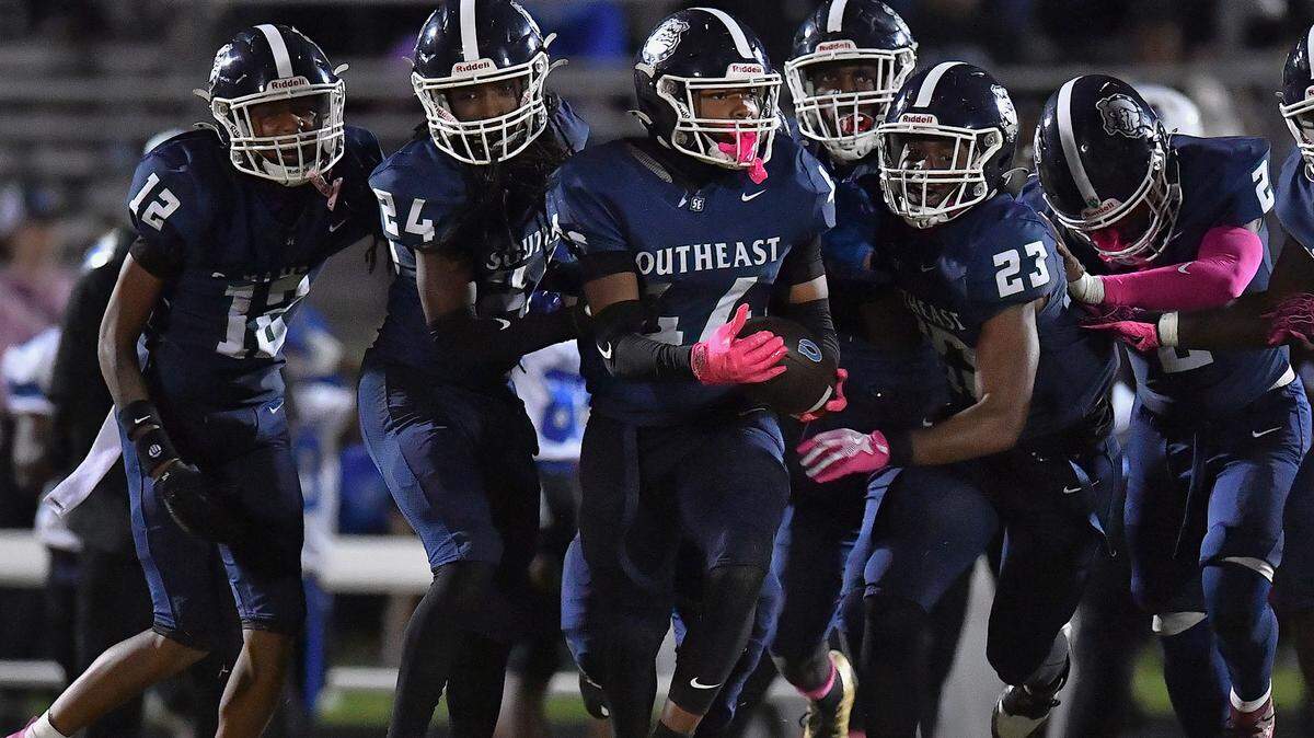 Southeast Raleigh linebacker Cyrus Gunther (44) carries the ball and celebrates with teammates after making the interception against Clayton late in the second half. The Southeast Raleigh Bulldogs and the Clayton Comets met in a conference football game in Raleigh, N.C. October 3, 2025