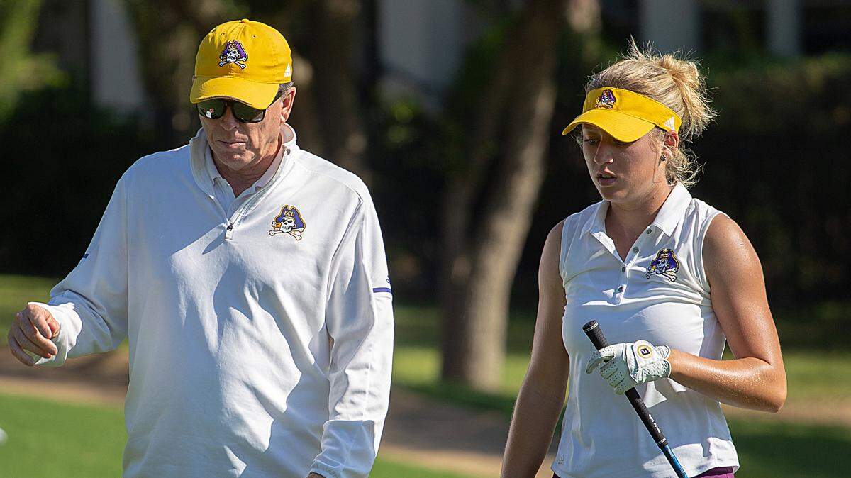 ECU junior golfer Carley Cox walks with coach Kevin Williams during a round at the 2018 NCAA Division I women's golf regional in Austin, Texas.